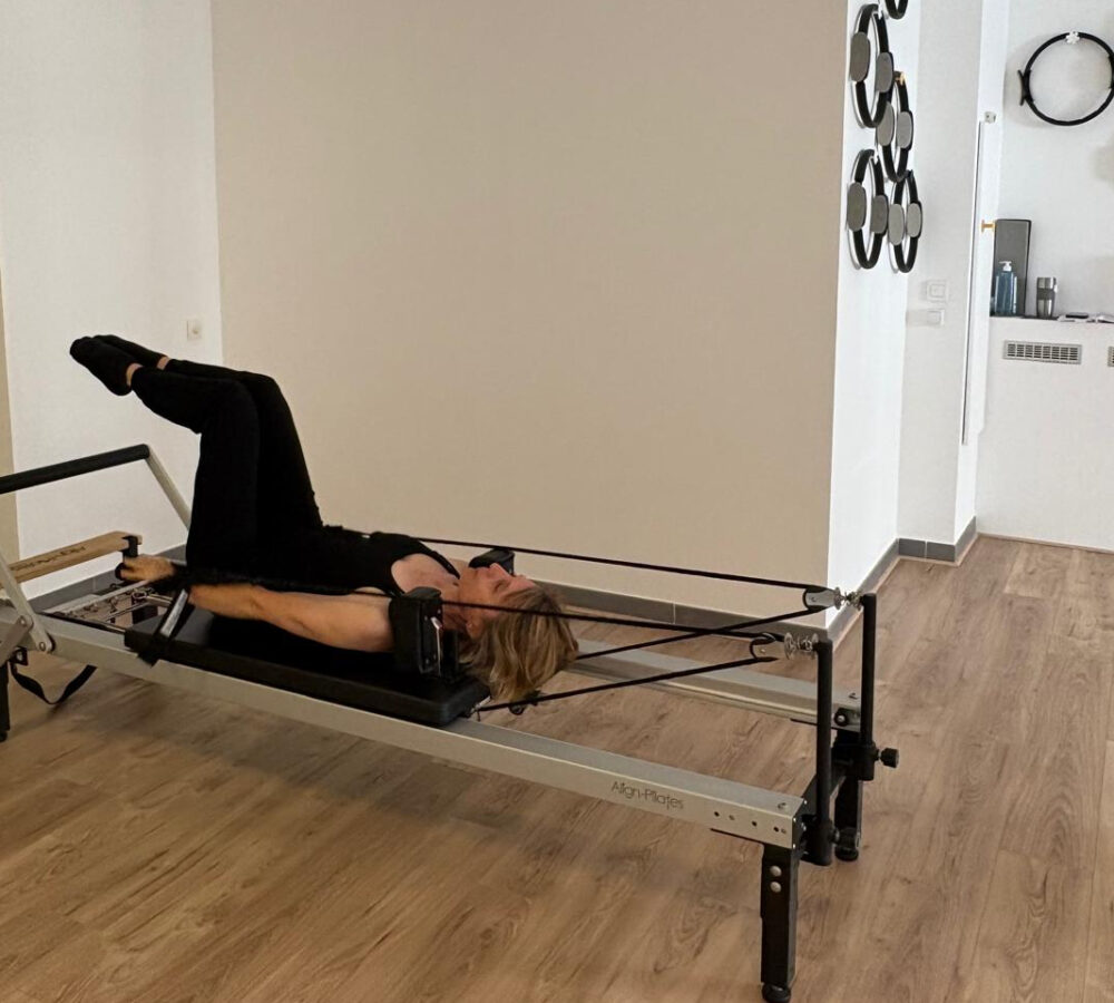 Arms on strap Pilates Reformer